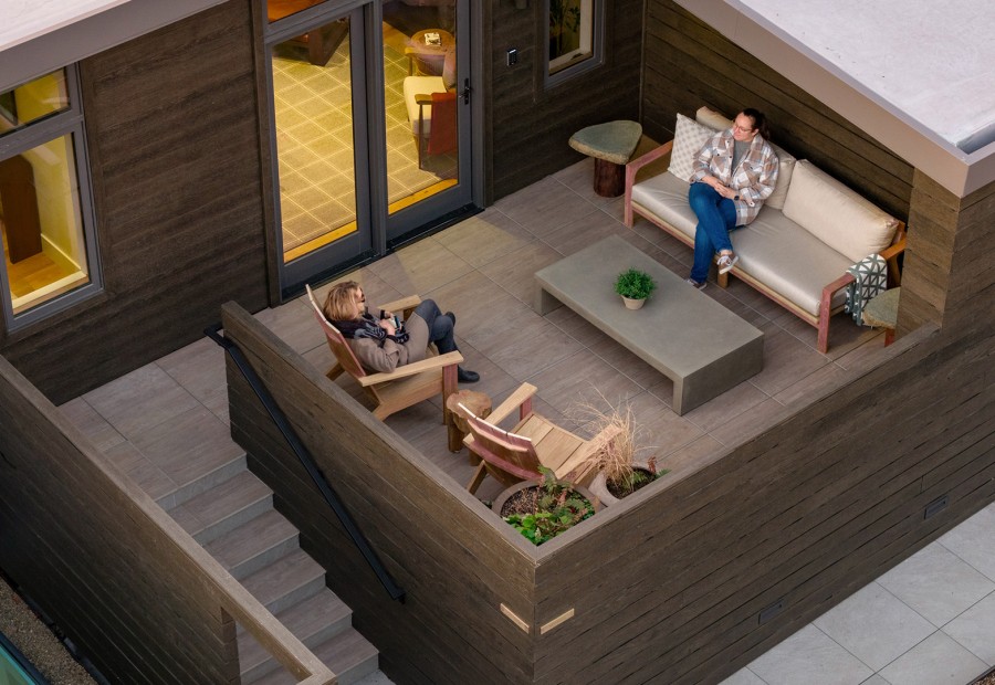 a couple of people sitting on a deck