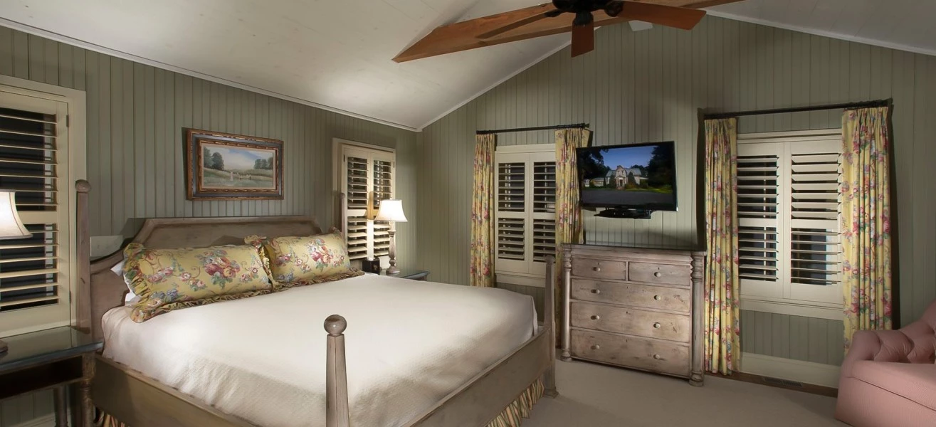 a bedroom with a large bed and a television