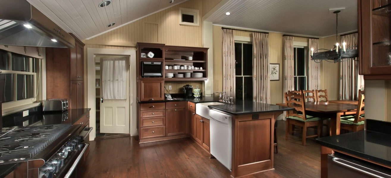 a kitchen with wood floors and a black countertop
