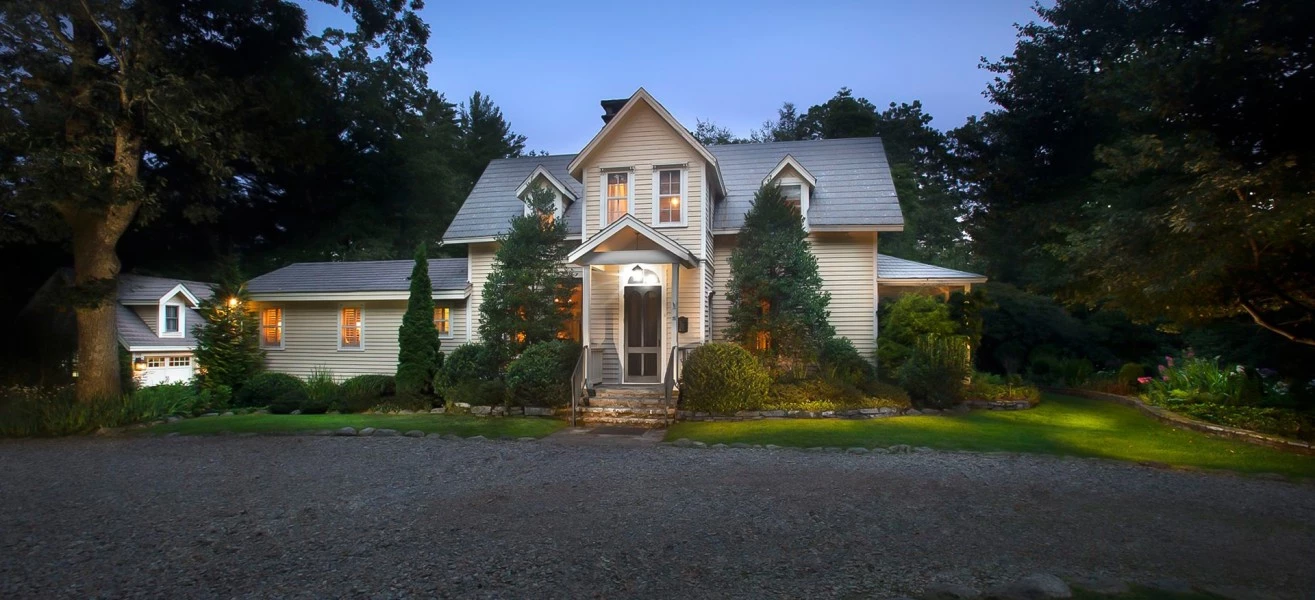 a house with a driveway and trees
