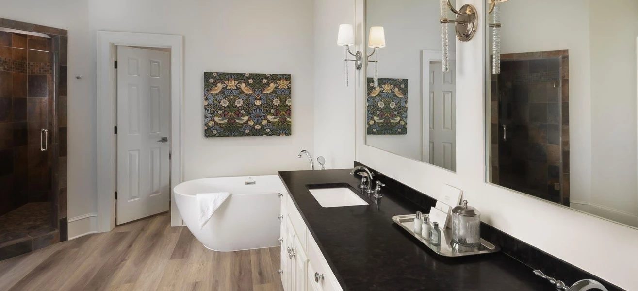 a bathroom with a black countertop and a tub