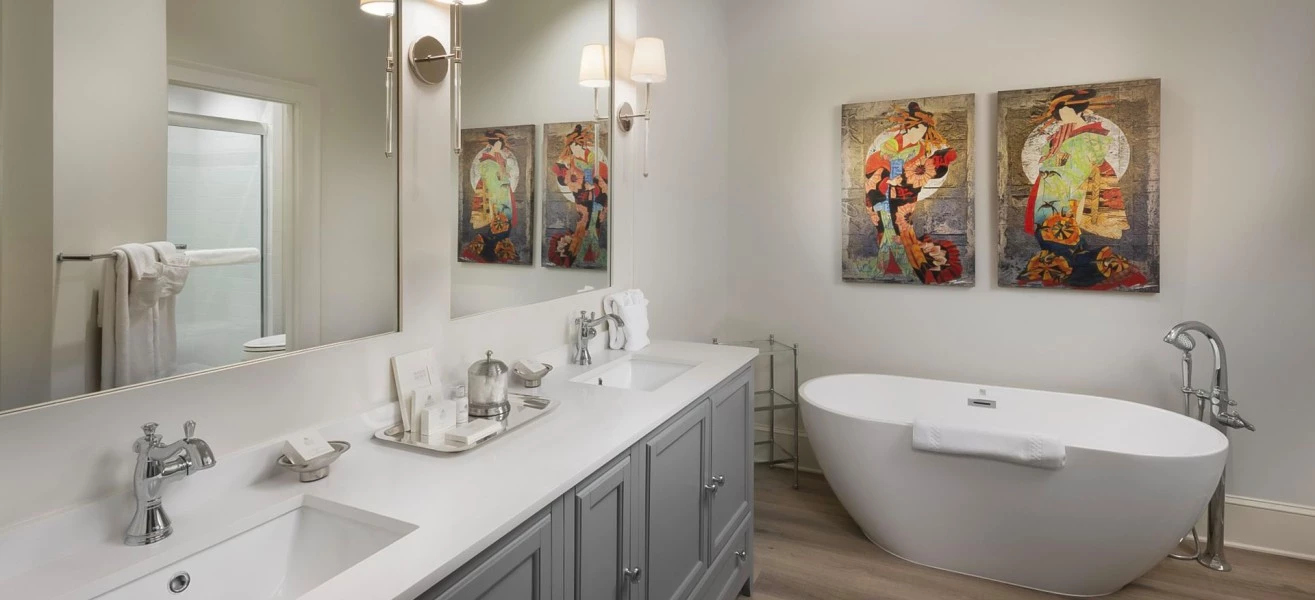 a bathroom with a tub and two sinks
