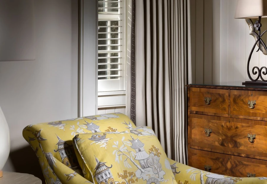a yellow chair next to a dresser