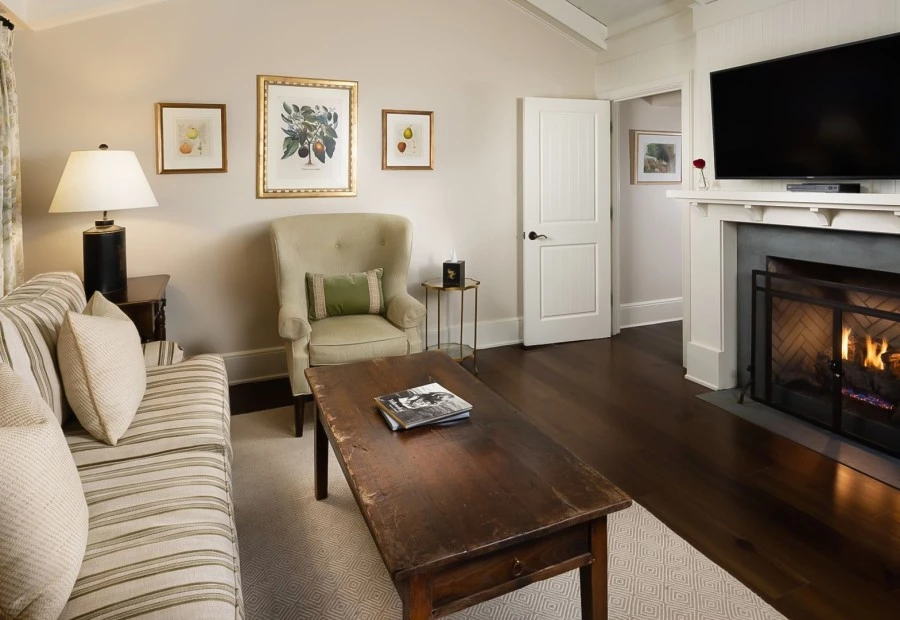 a living room with a fireplace and a coffee table