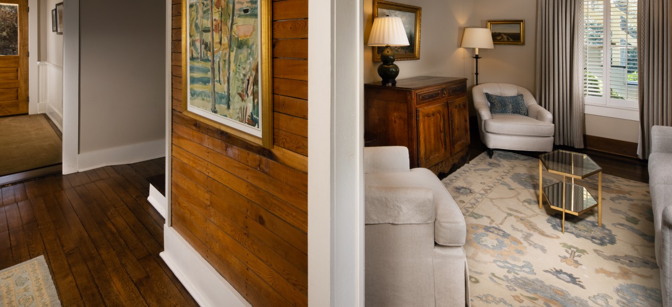a room with a wood paneled wall and a white couch