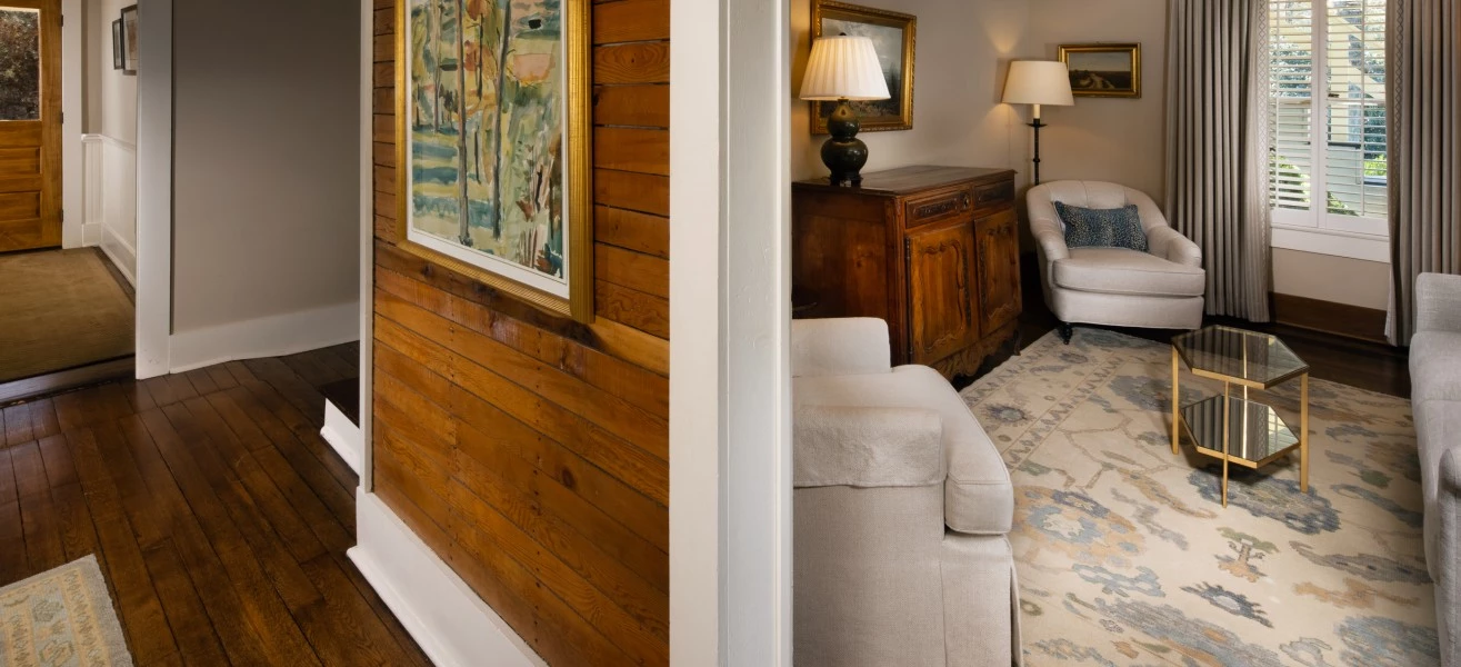 a room with a wood paneled wall and a white couch