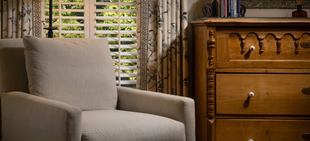 a chair next to a dresser