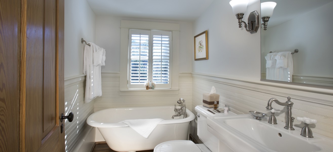 a bathroom with a tub toilet and sink