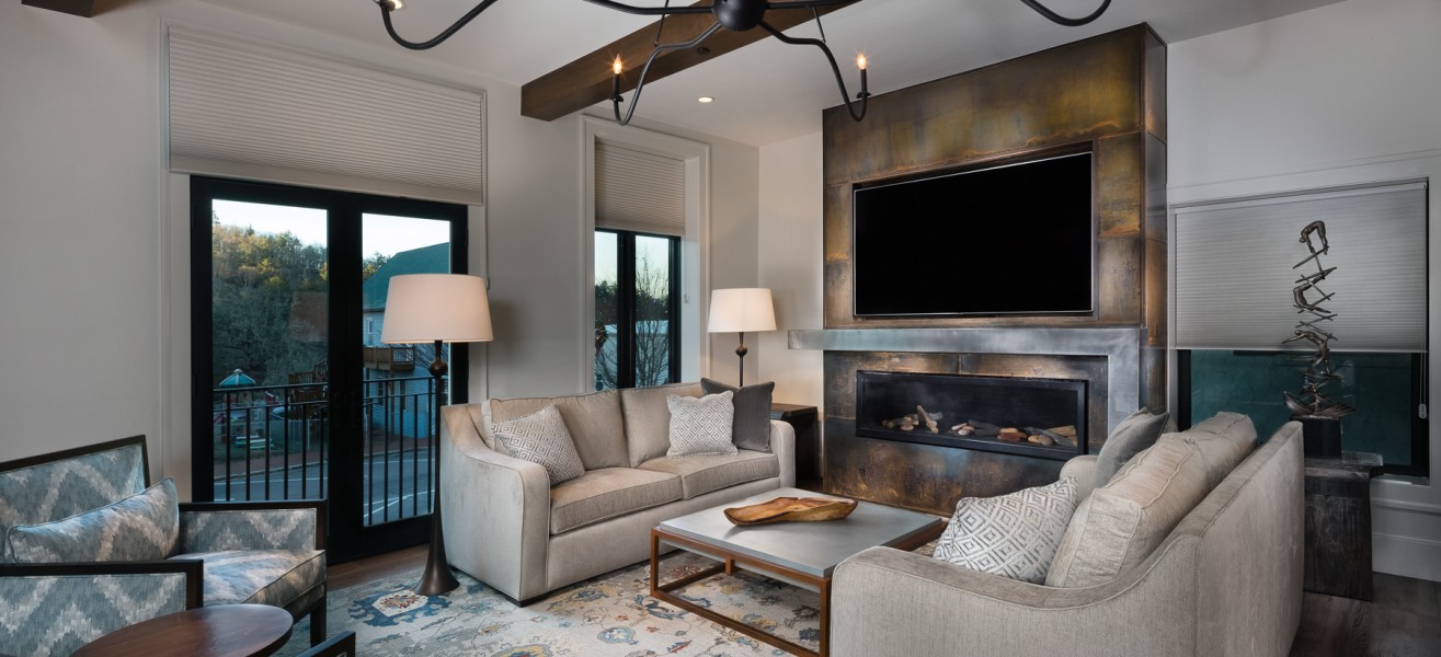 a living room with a fireplace and couches