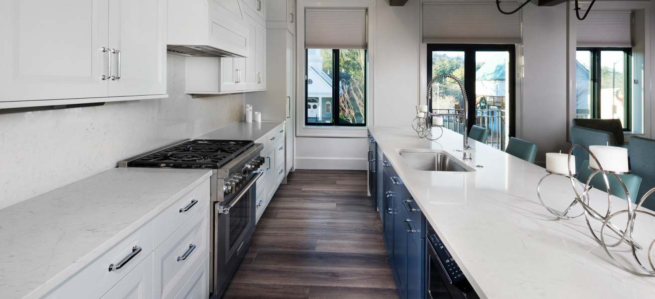 a kitchen with white cabinets and blue cabinets