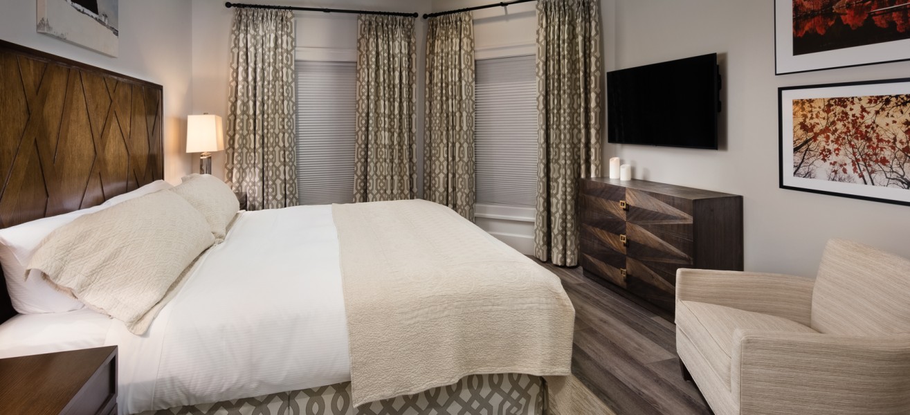 a bedroom with a bed and a television