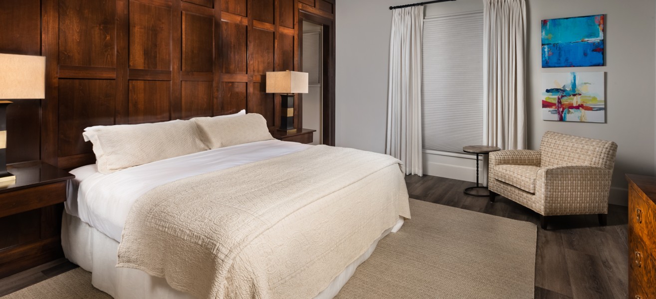 a bedroom with a bed and a chair