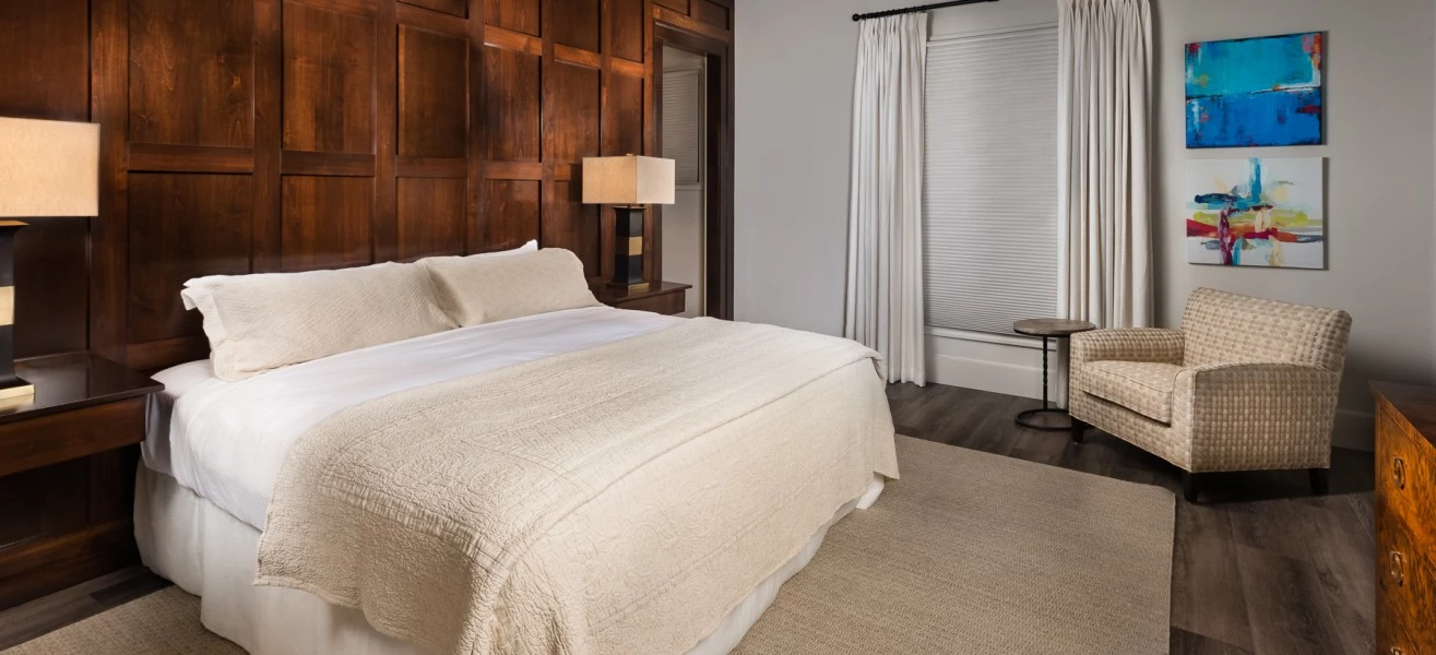 a bedroom with a bed and a chair