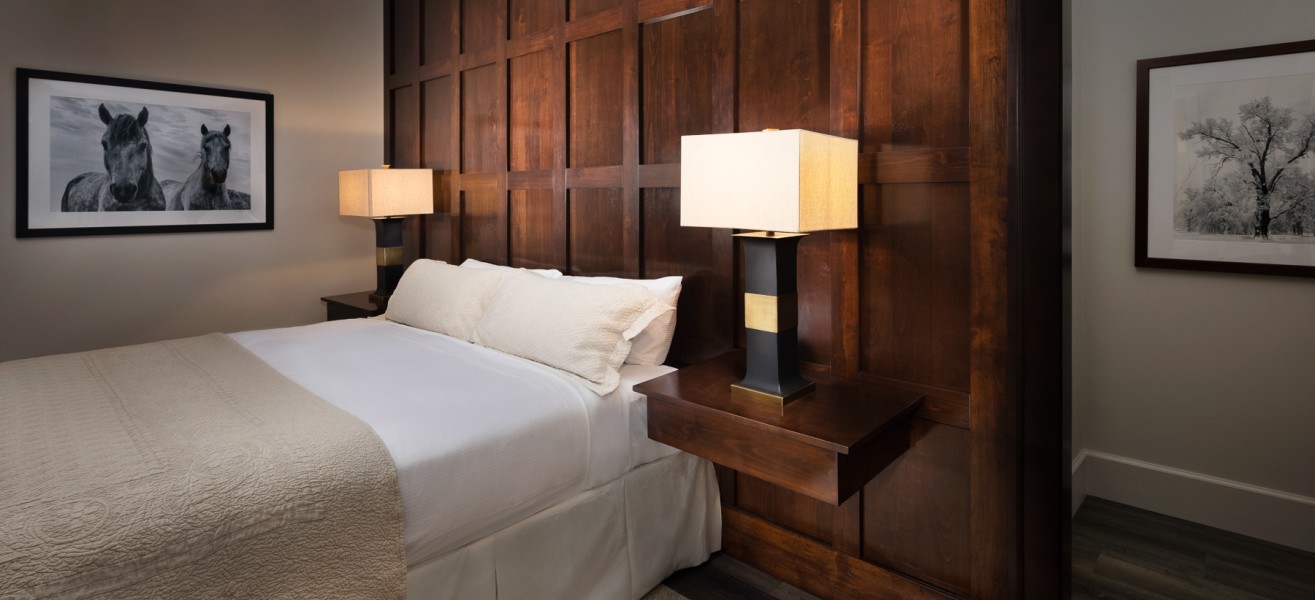 a bed with a lamp on the headboard