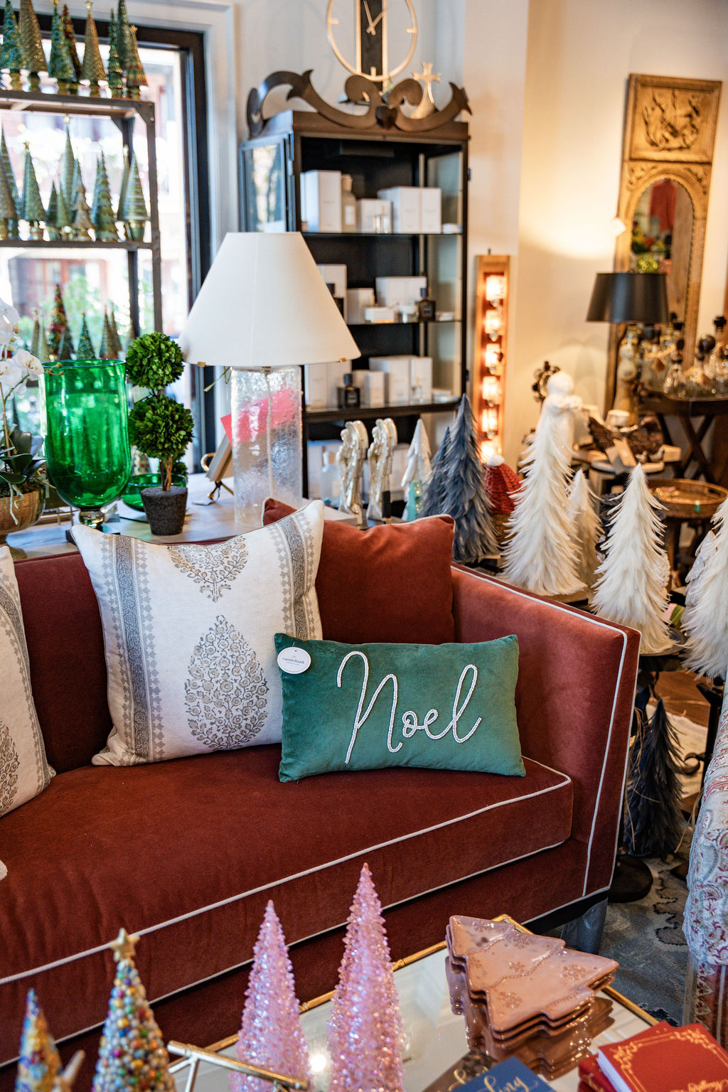 a couch with pillows and a green pillow on it