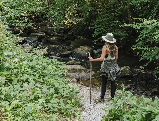 a woman standing in a forest