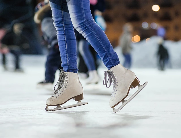 a person's legs in ice skates