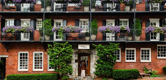 a building with plants on the balconies