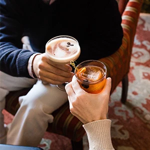 a couple of people holding drinks