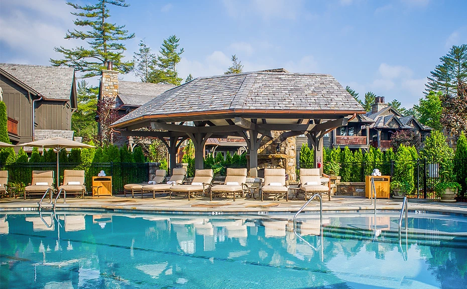 a pool with chairs and a gazebo