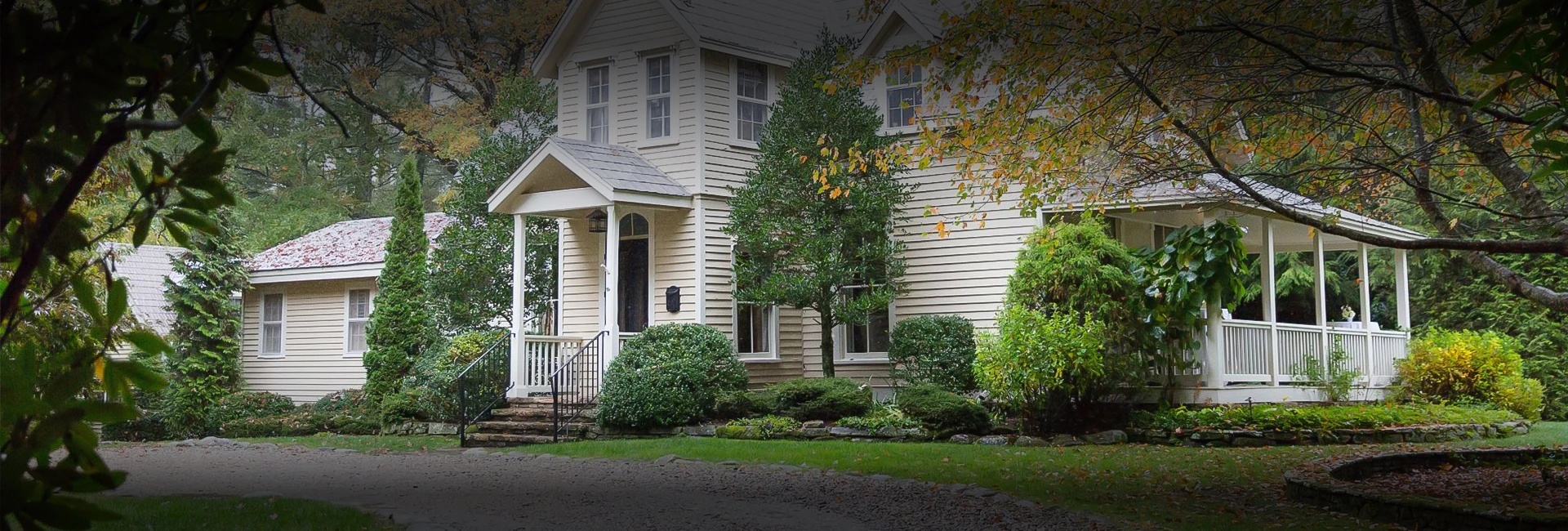 a house with a driveway and trees