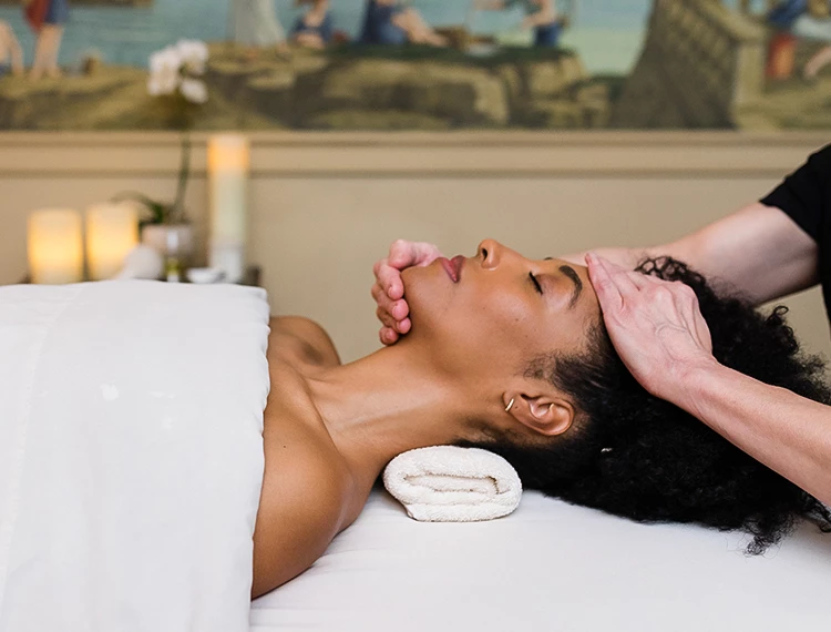 a woman receiving a face massage