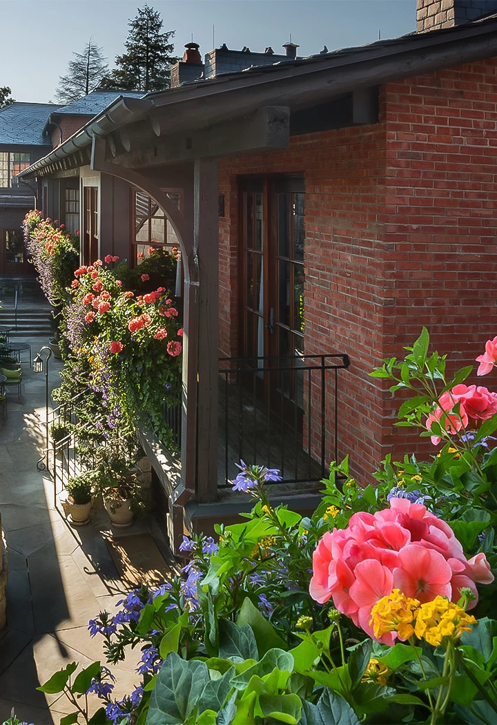 a brick building with flowers on the side