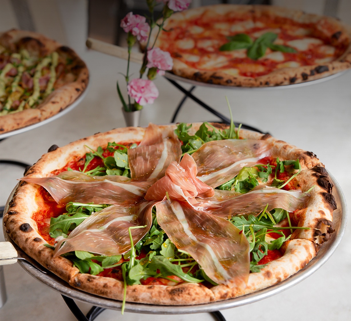 a pizza with bacon on it