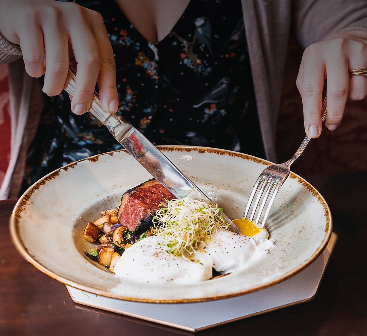 a person eating food with a fork and knife