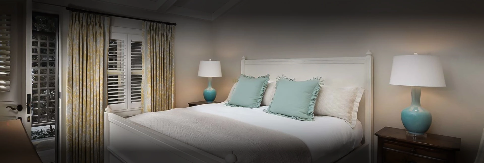 a bed with pillows and a lamp