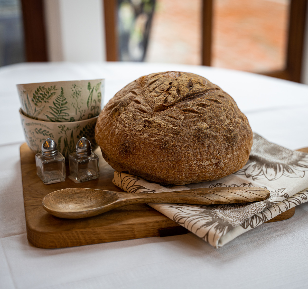 a bread and a spoon on a wooden board