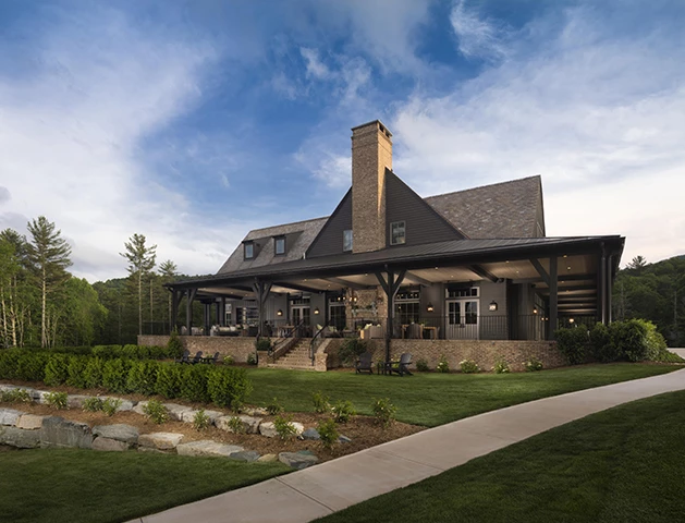 a house with a large porch and a lawn