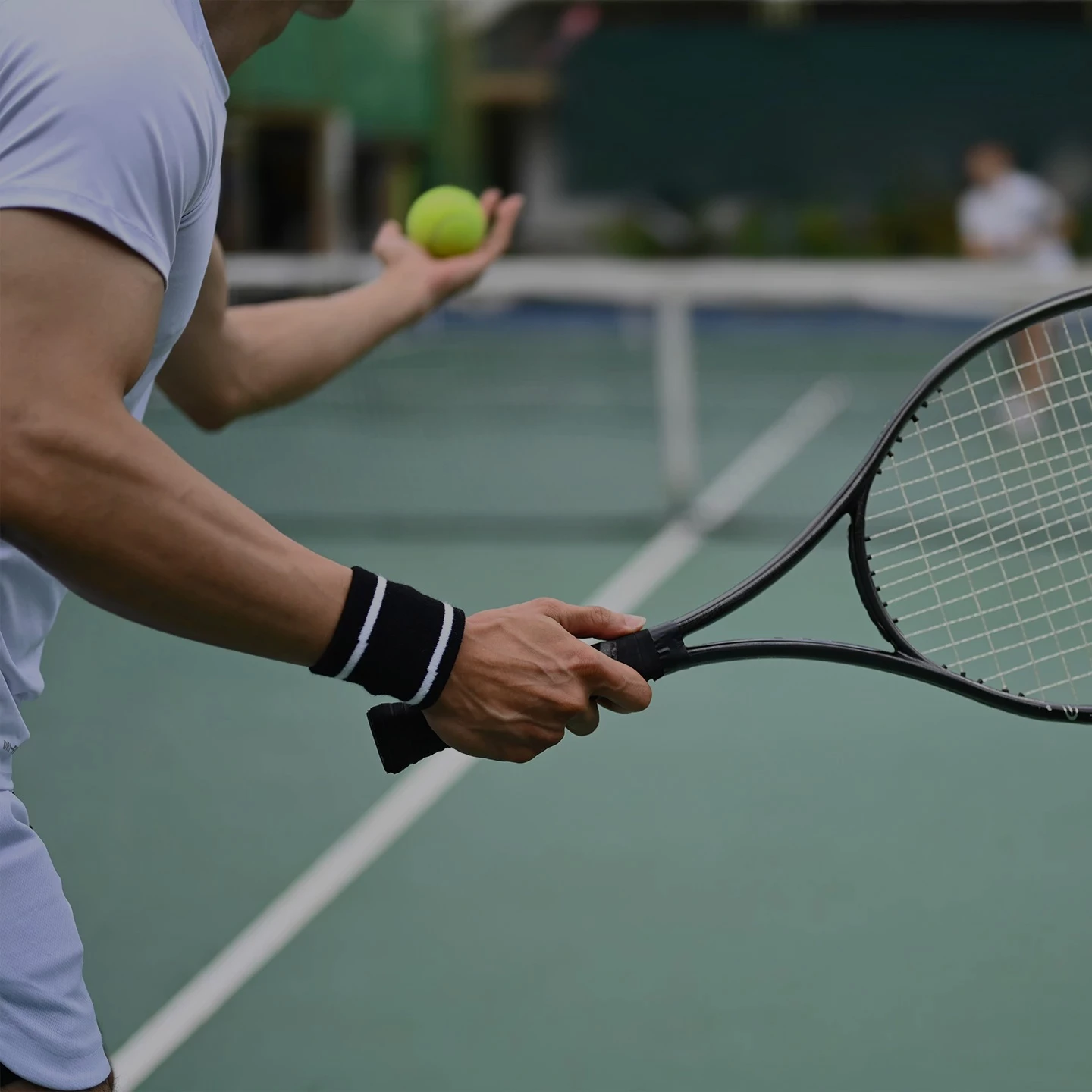 a man holding a tennis racket and a ball
