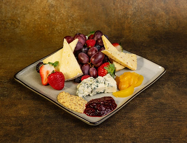 a plate of fruit and cheese
