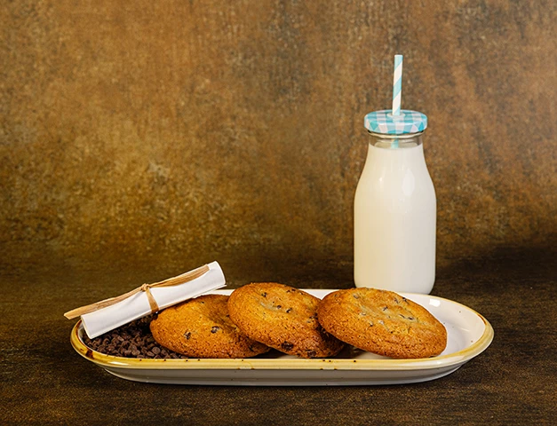 a plate of cookies and a bottle of milk