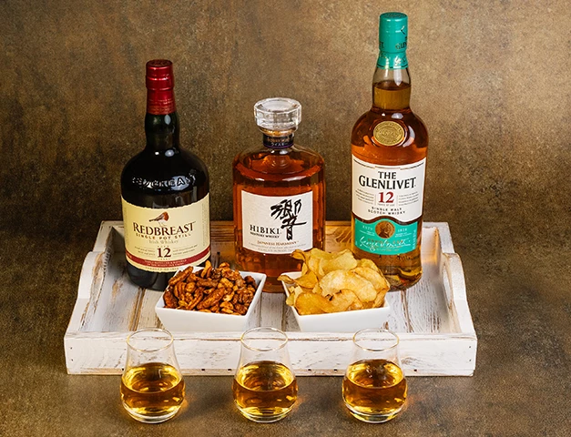 a tray of liquor and snacks