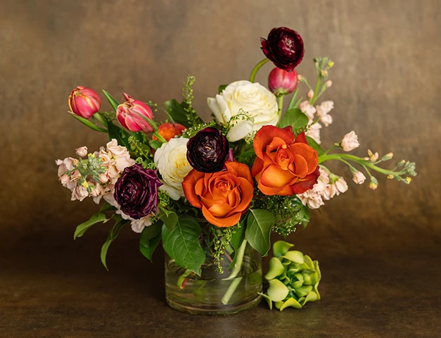 a bouquet of flowers in a glass vase