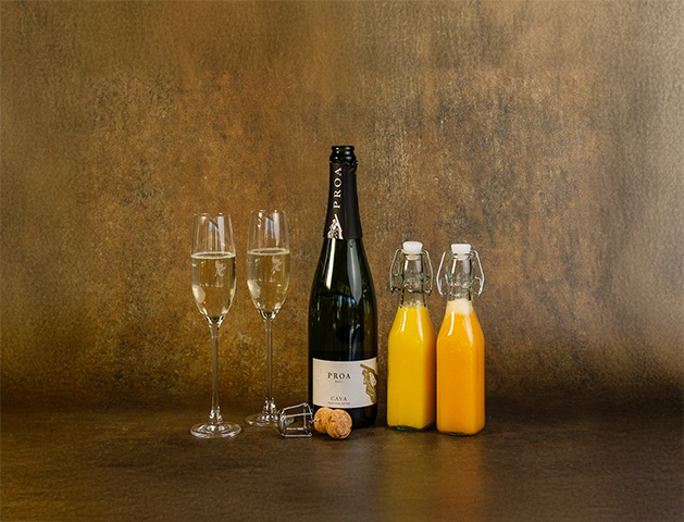 a bottle of champagne next to two glasses of champagne