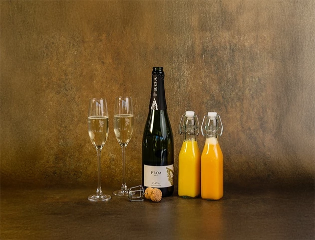 a bottle of champagne next to two glasses of champagne