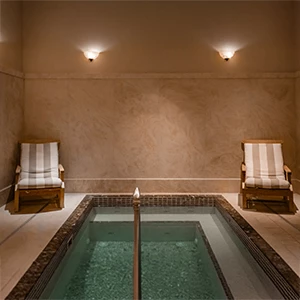a pool with chairs in the middle