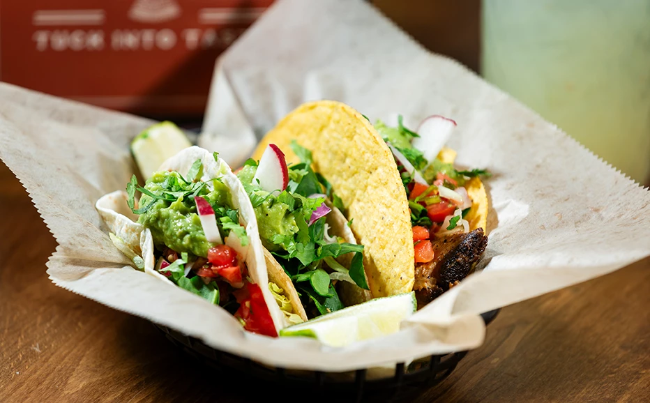 a basket of tacos on a table