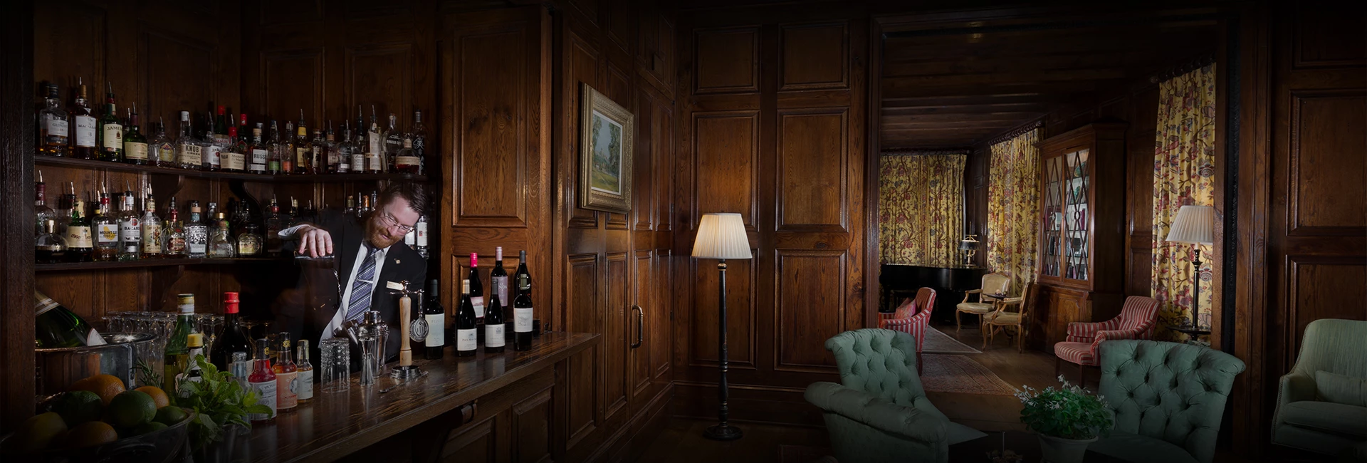 a room with a table lamp and wine bottles