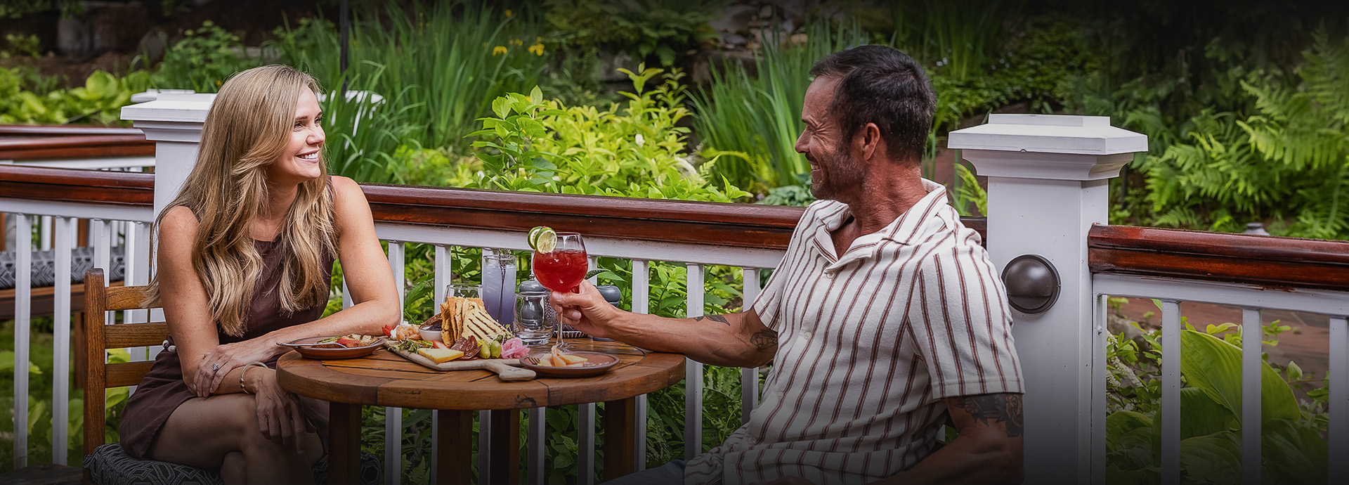 a man sitting at a table with a glass of wine