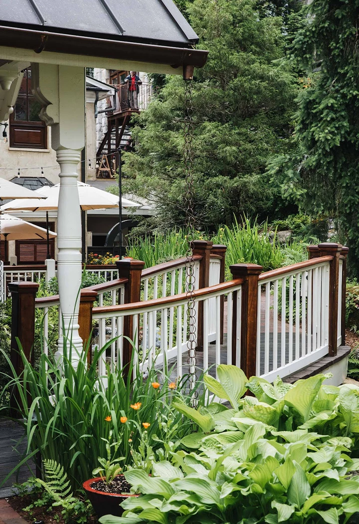 a white railing with plants and trees