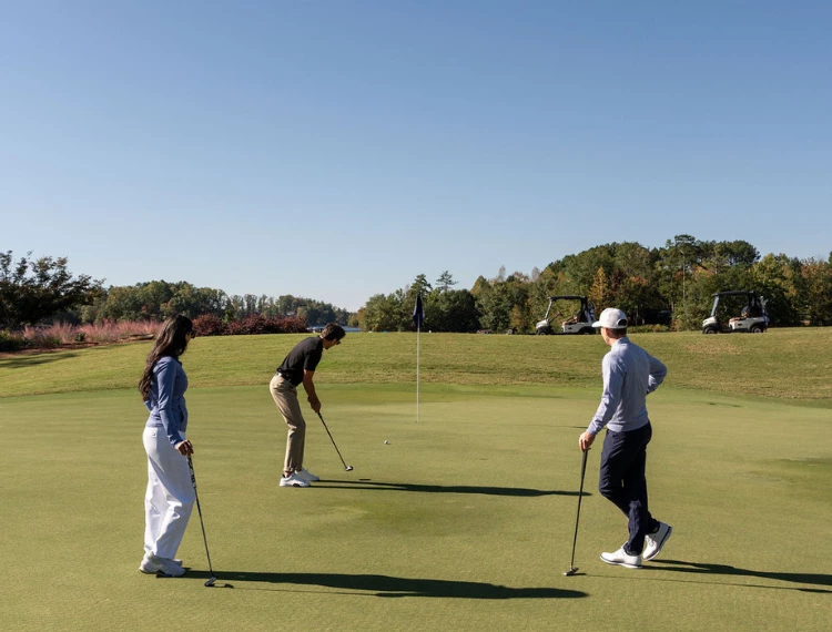 a group of people playing golf
