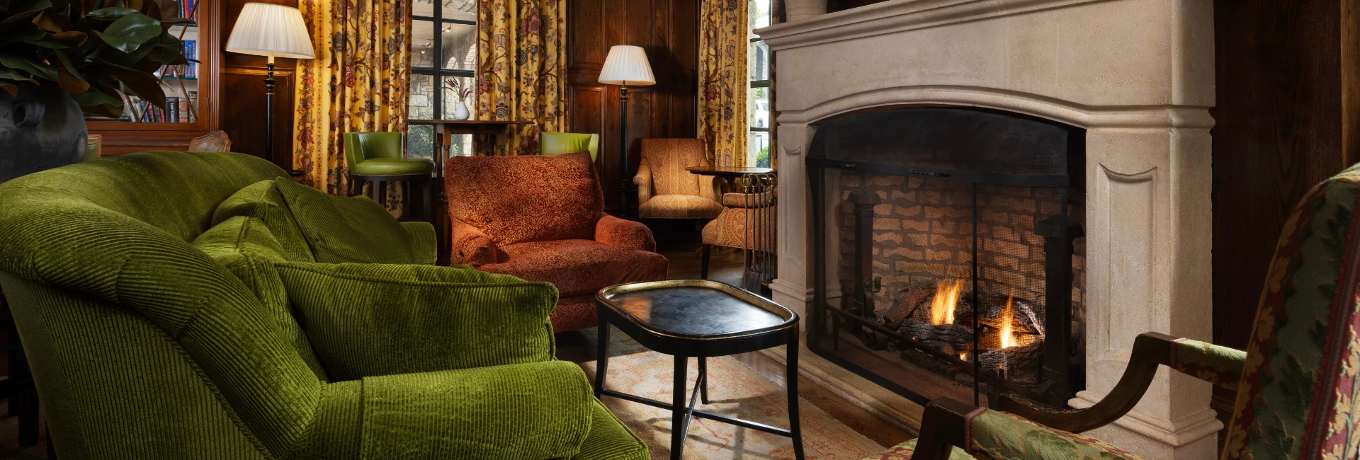 a living room with a fireplace and chairs