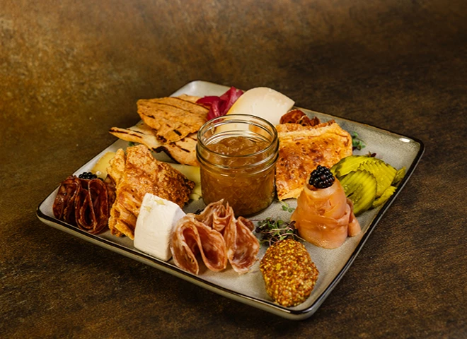 a plate of food with a jar of jam