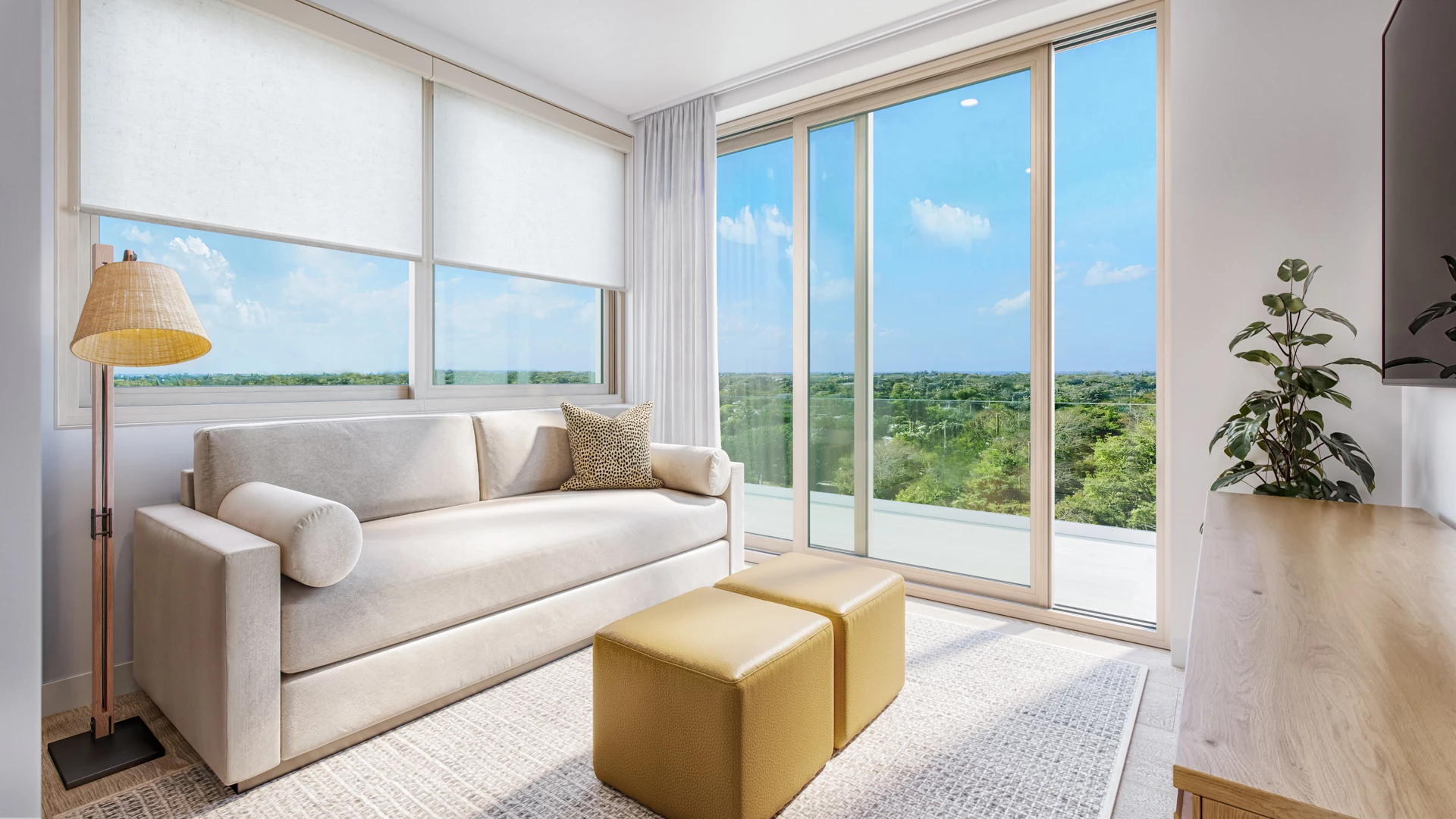 a white couch and two stools in a room with a view of the landscape