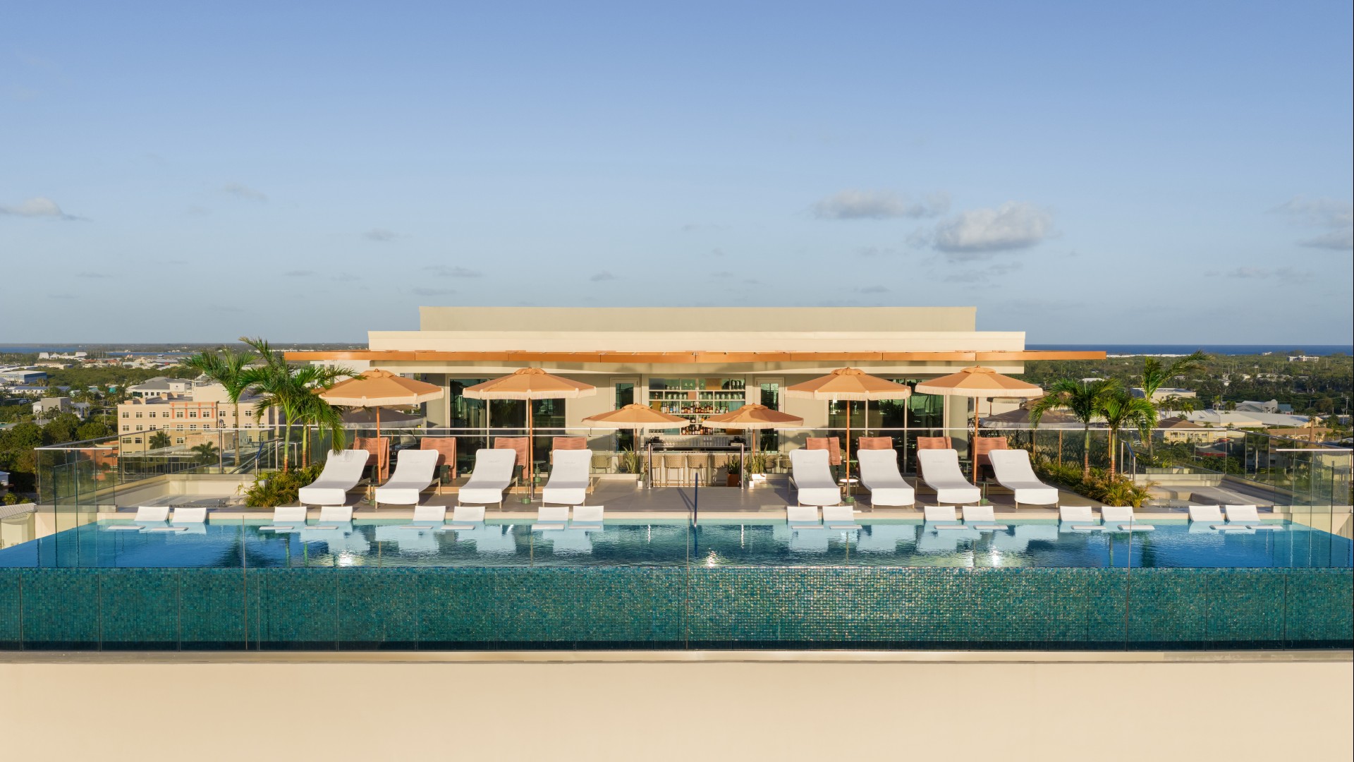 a pool with lounge chairs and umbrellas