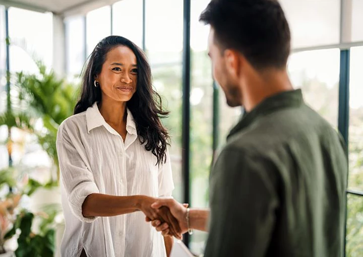 a woman shaking hands with a man